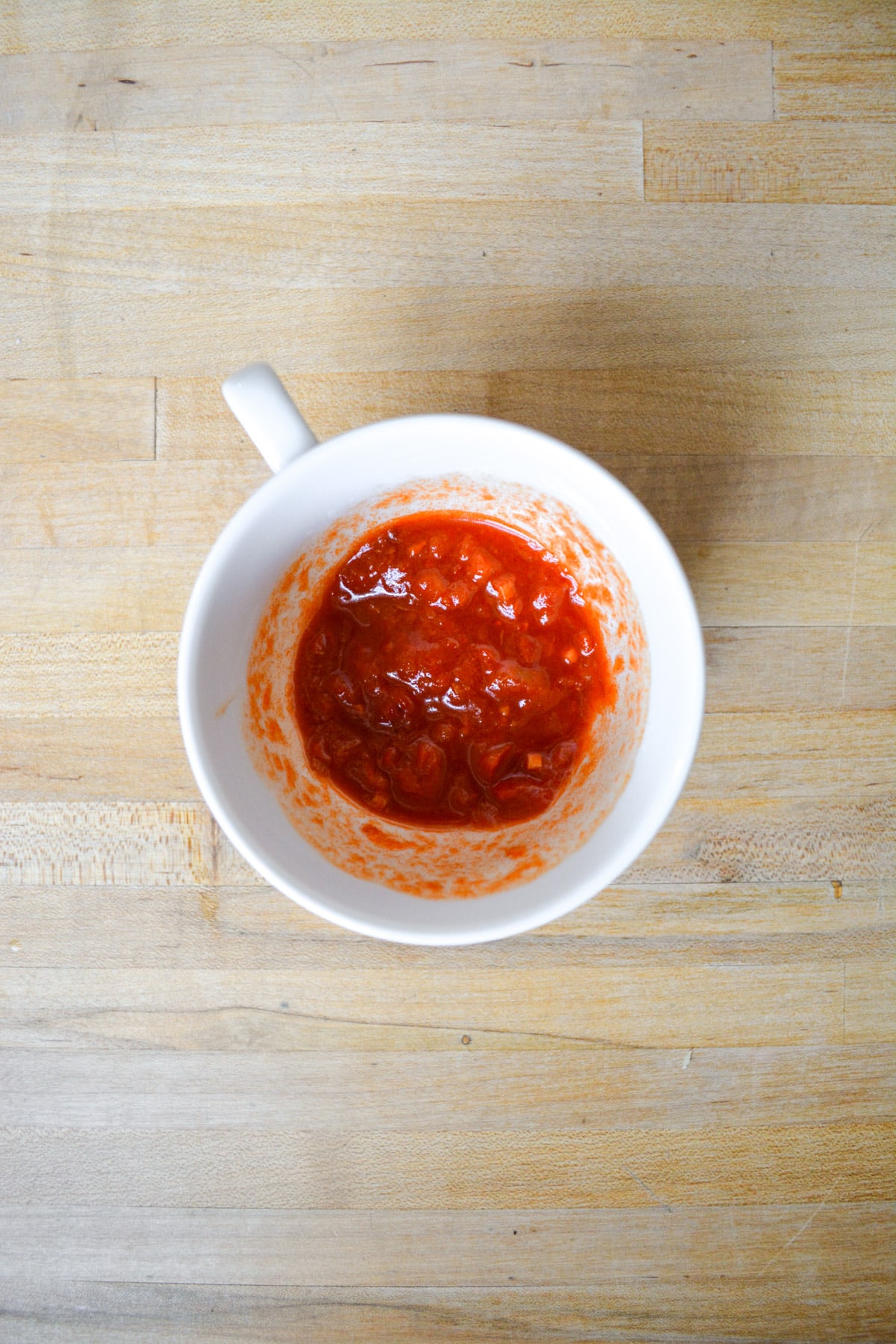 Harissa and lemon juice in a small cup.