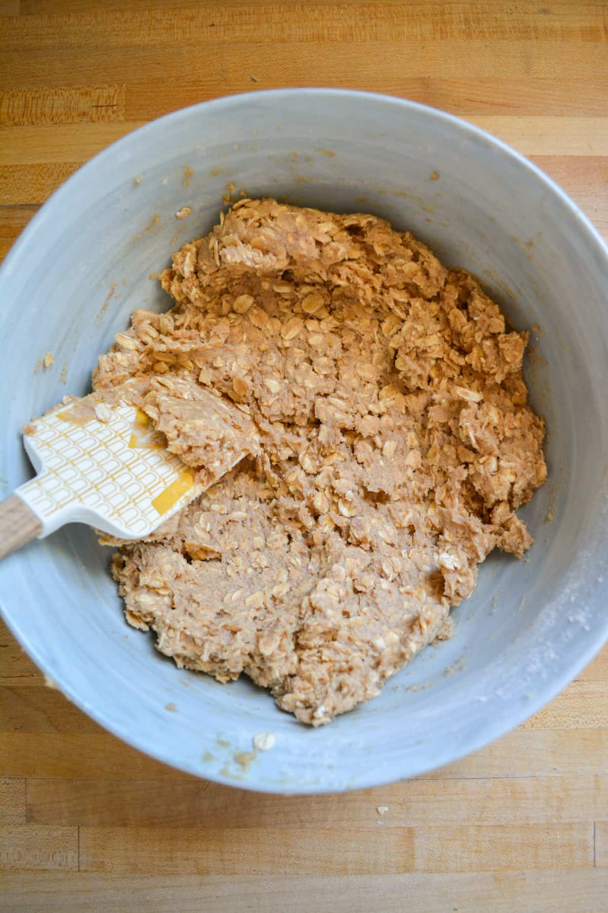 Flour and rolled oats added to the creamed mixture to form the vegan oatmeal cookie dough.