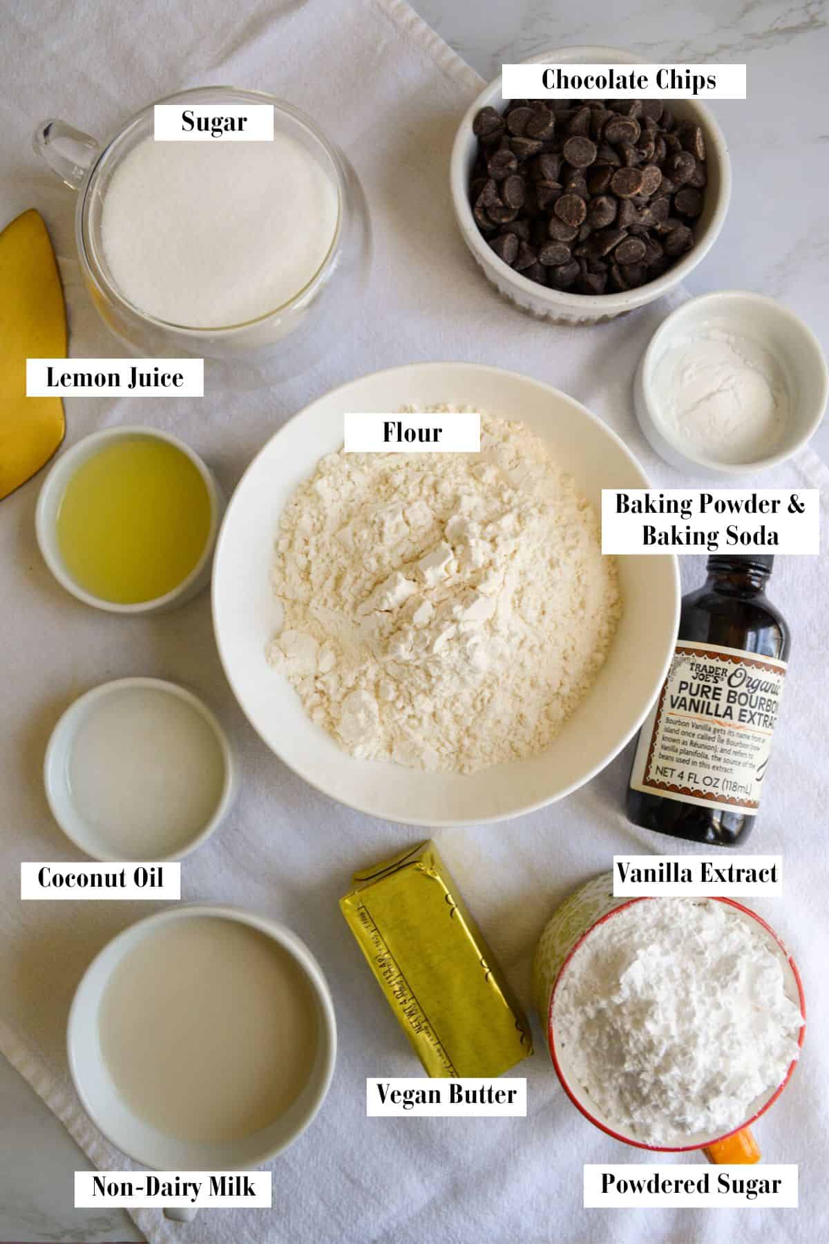 Ingredients needed for making this vegan cake pop recipe in small bowls on a white cloth.