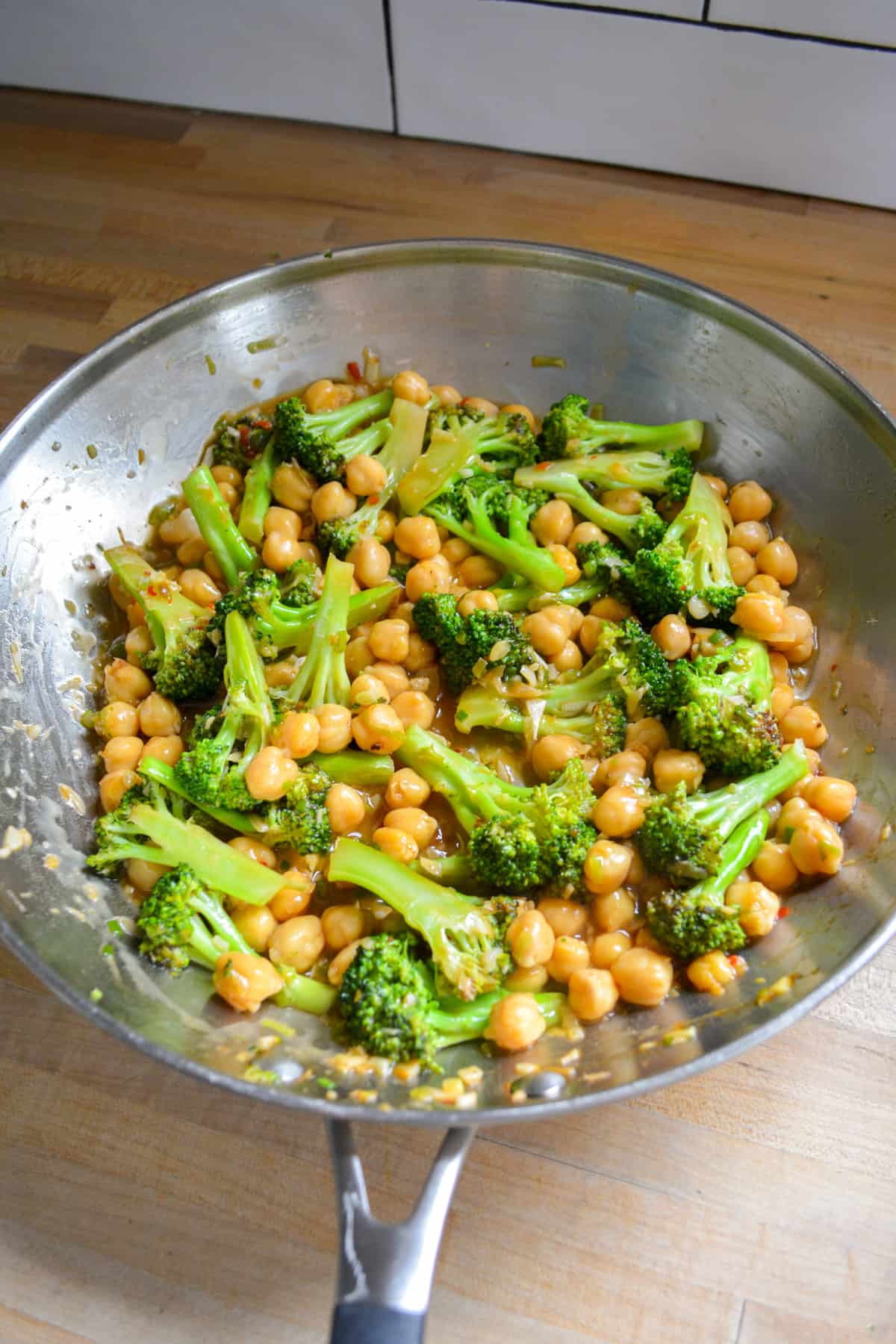 Finished Vegan Chickpea Broccoli Stir Fry in a stainless steel skillet.