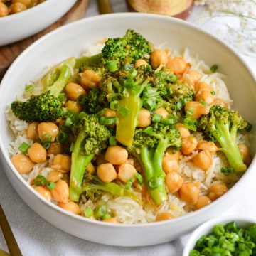 Vegan Chickpea Broccoli Stir Fry on top of rice in a wide shallow bowl.