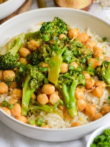 Vegan Chickpea Broccoli Stir Fry on top of rice in a wide shallow bowl.