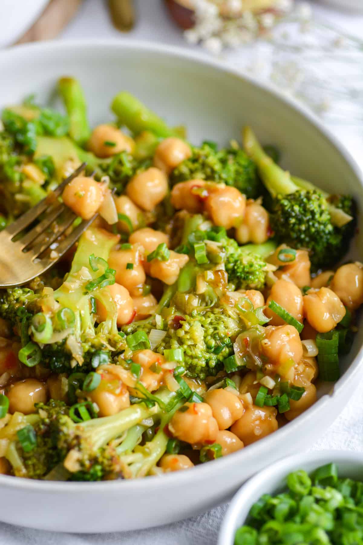 Vegan Chickpea Broccoli Stir Fry in a bowl with a fork to the left.
