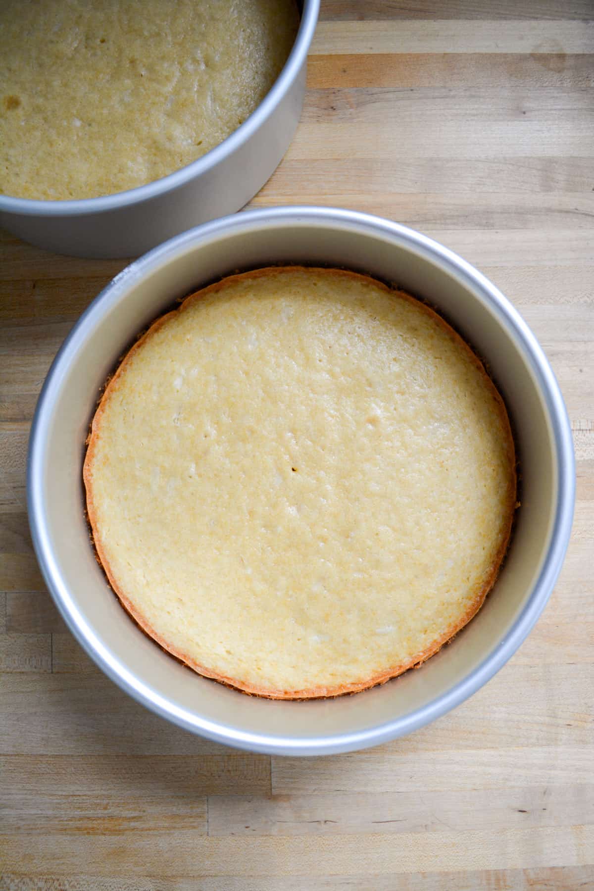 Baked cake layers in the round cake pans.