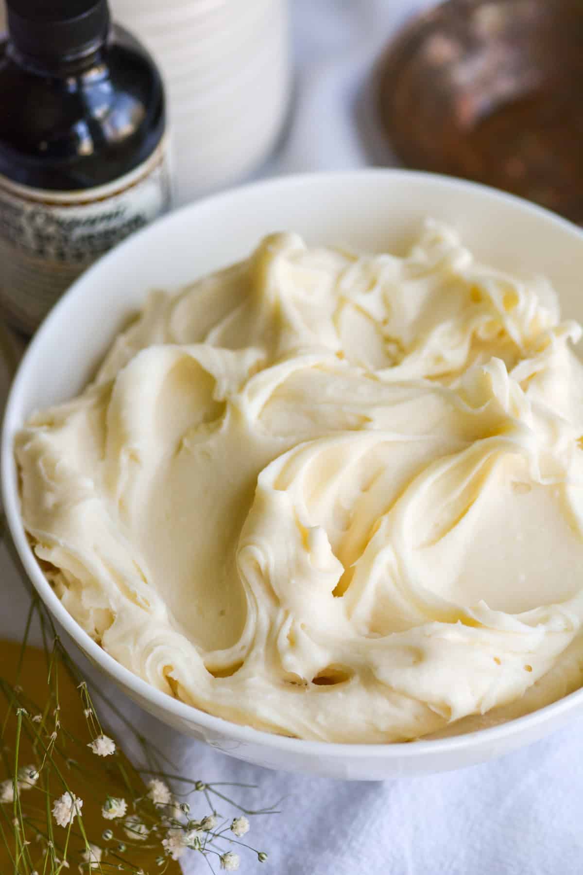 Vegan Cream Cheese Frosting in a bowl on a white cloth.