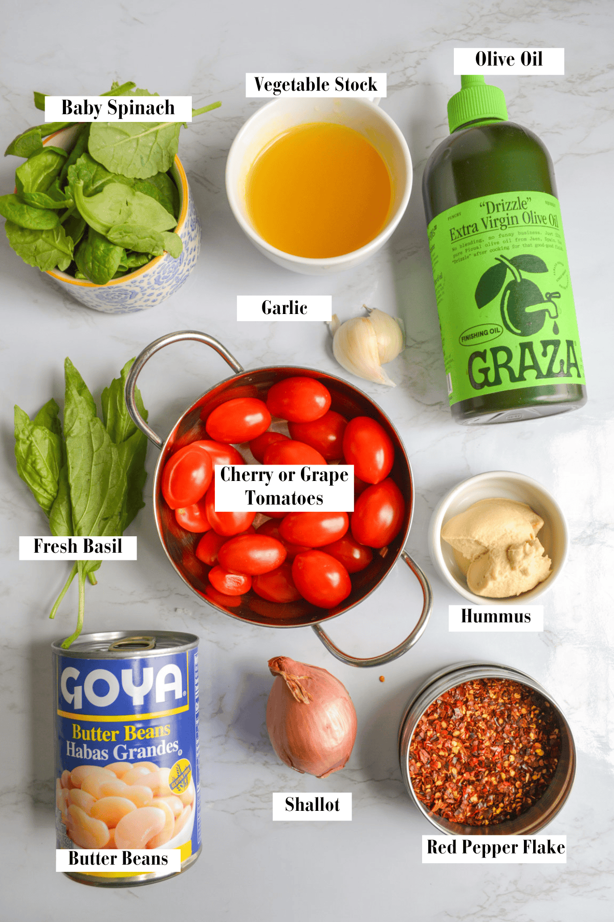 Ingredients needed to make this recipe in small bowls on a marble surface.