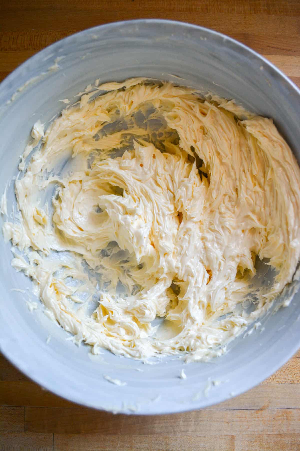 Vegan butter creamed until smooth in a mixing bowl.