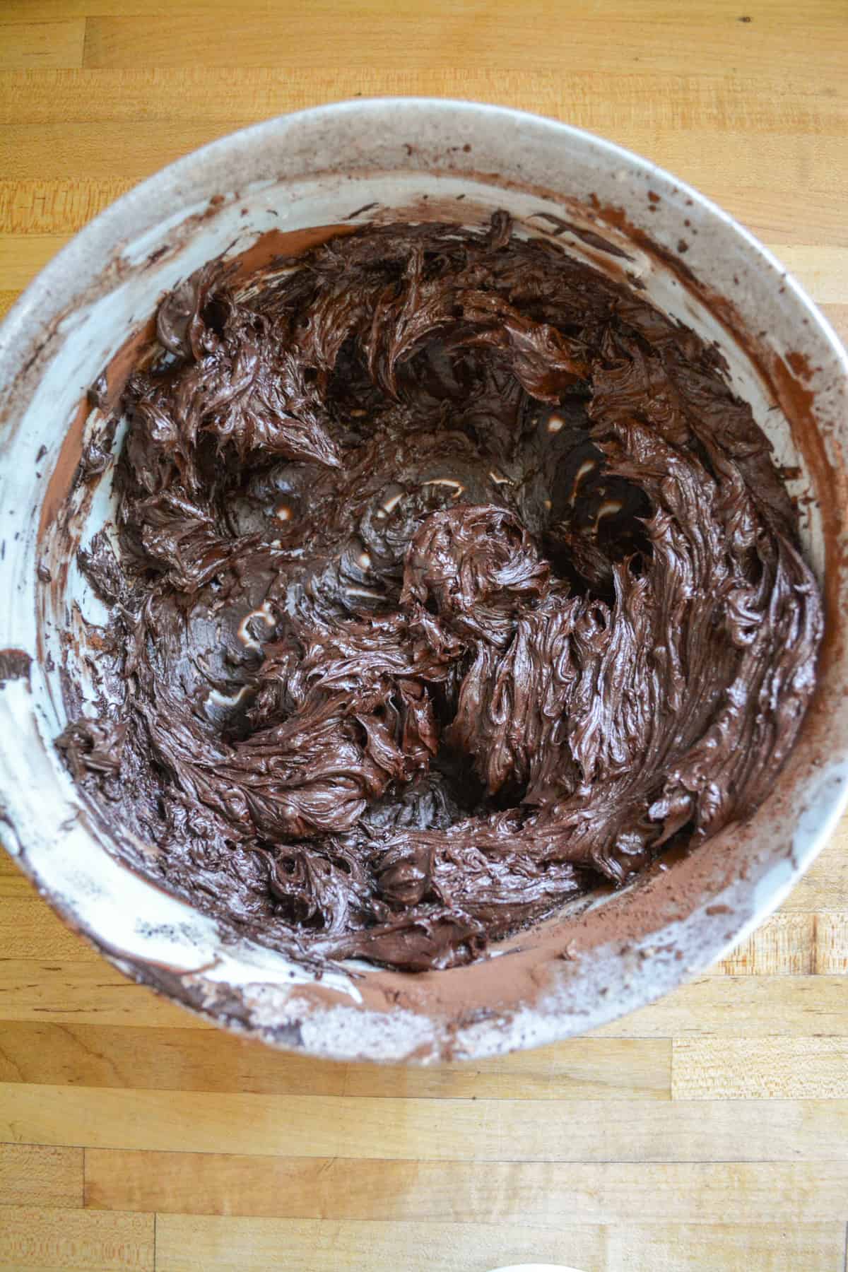 Cocoa powder mixed with vegan butter in a mixing bowl.