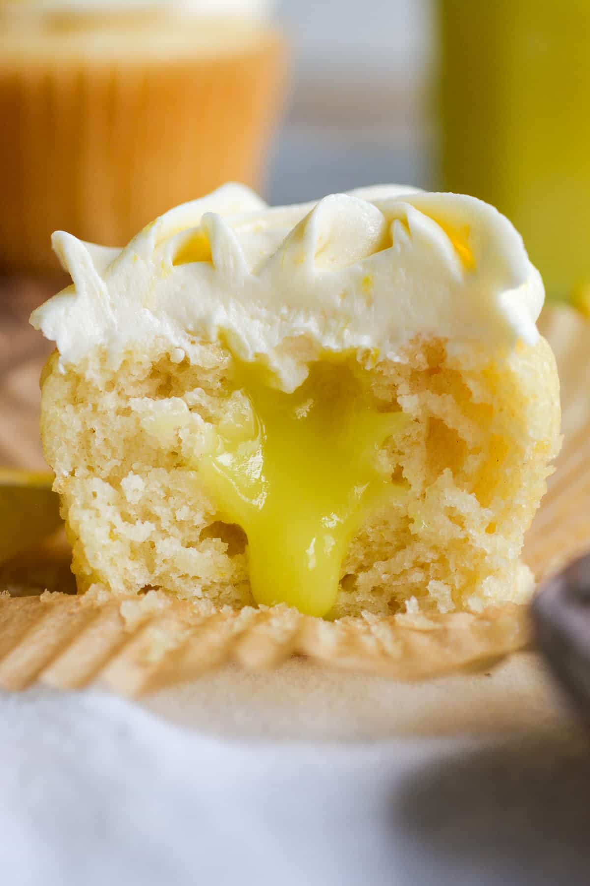 Vegan Lemon Curd Filled Cupcake cut in half to show the lemon curd filling.