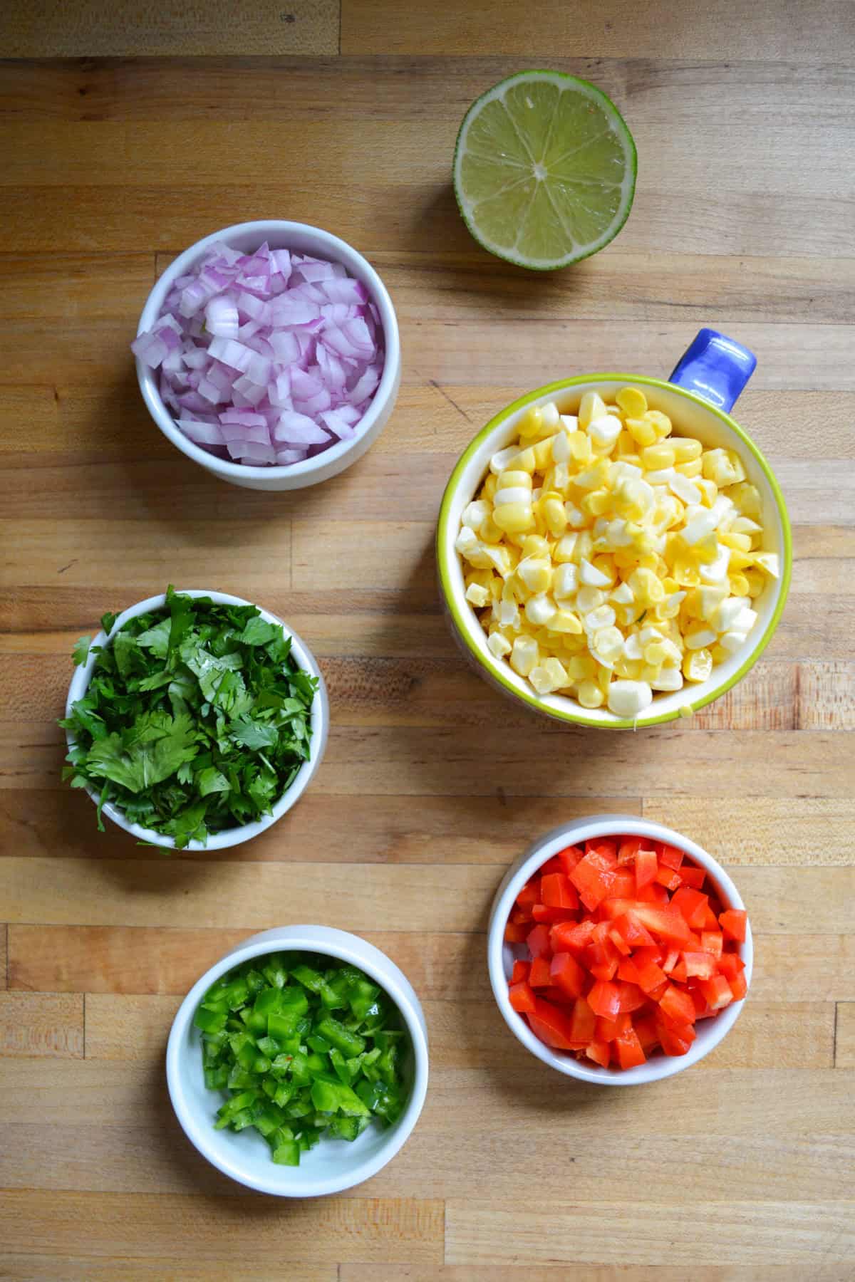 Ingredients for Easy corn salsa chopped up and added put into small bowls.