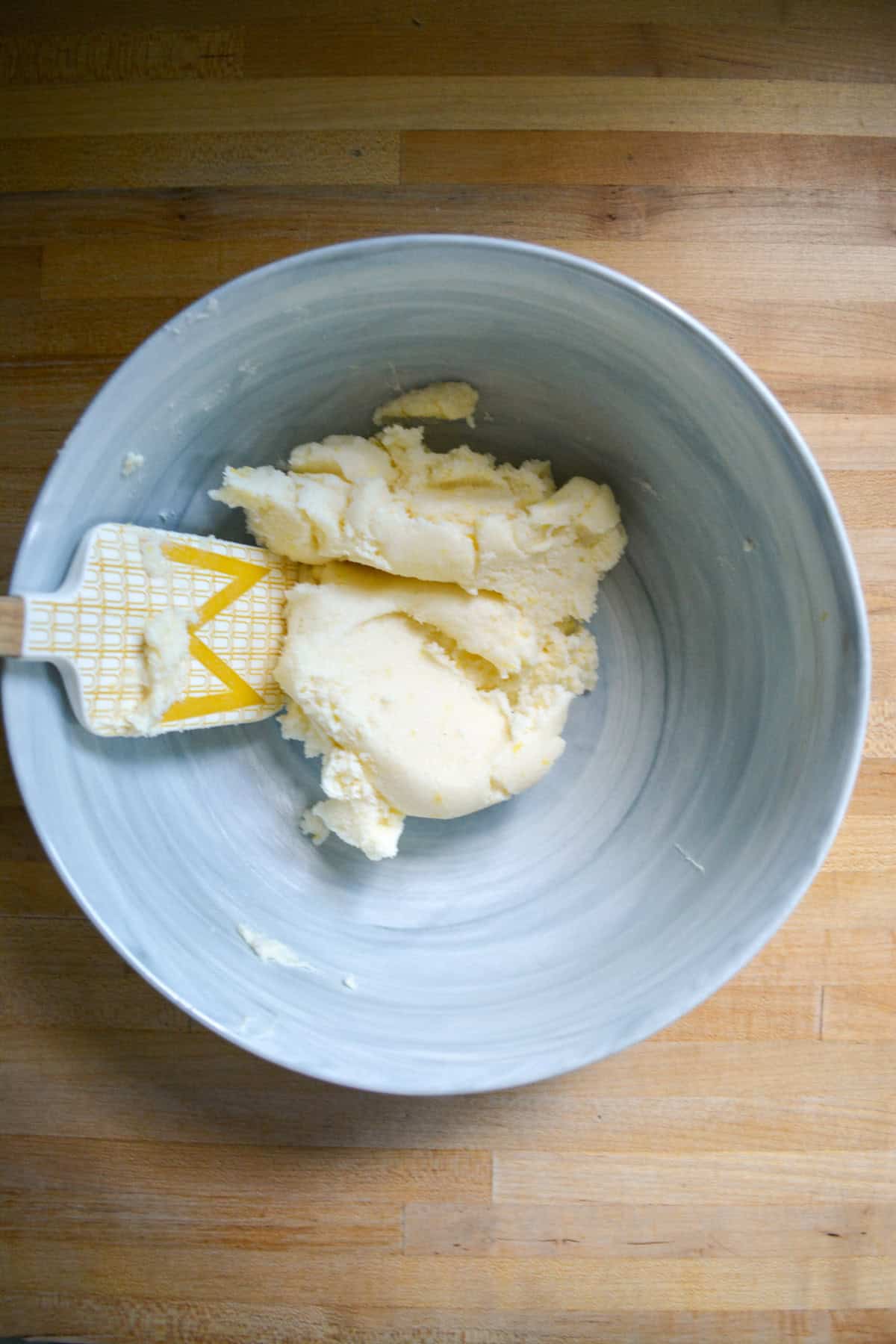 Vegan butter, sugar and lemon zest creamed together in a mixing bowl.