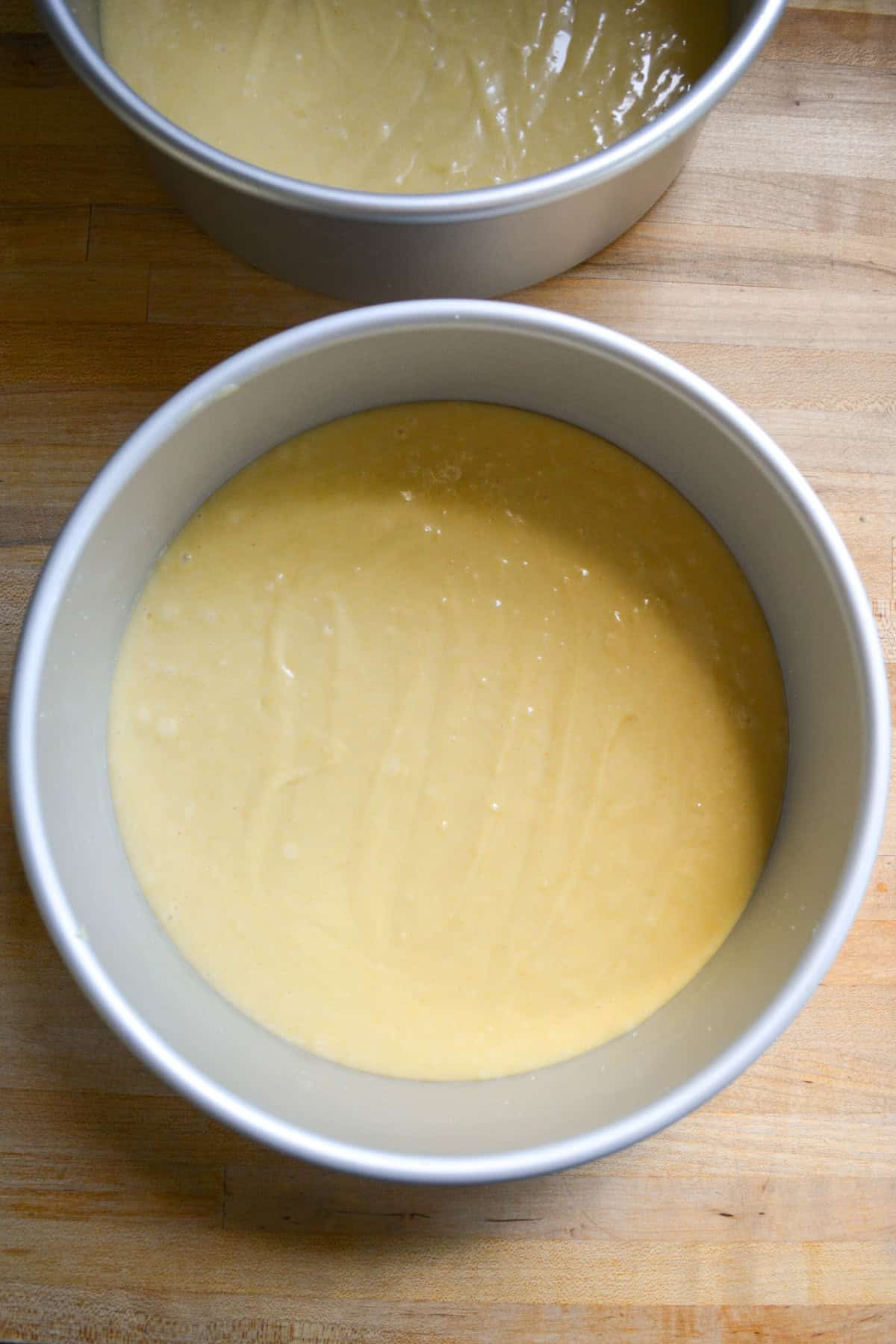Cake batter divided into two prepared 8-inch round cake pans.