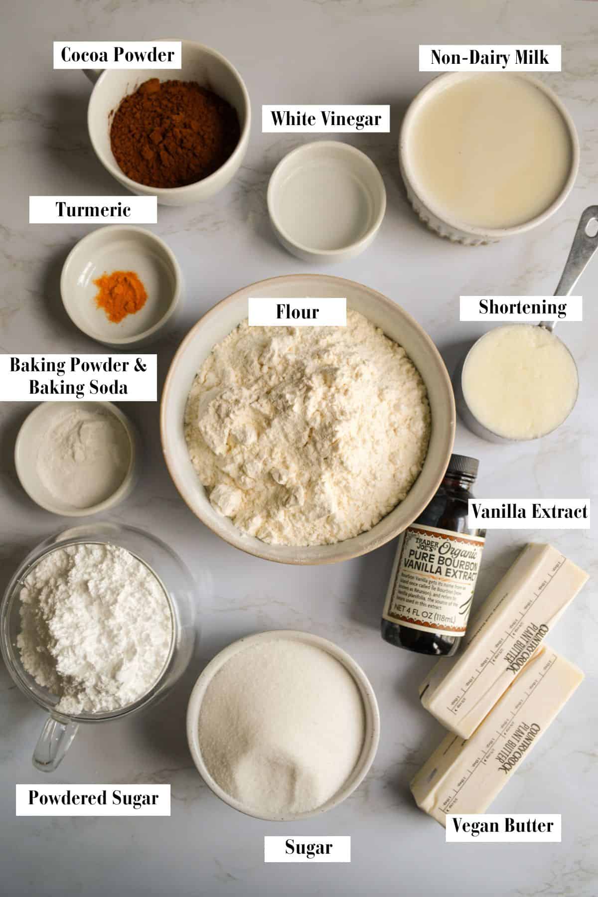 Ingredients needed to make this recipe in small bowls and cups on a marble surface.