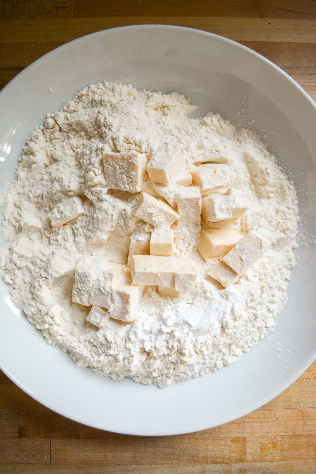 Dry ingredients and cold cubed vegan butter in a large mixing bowl.