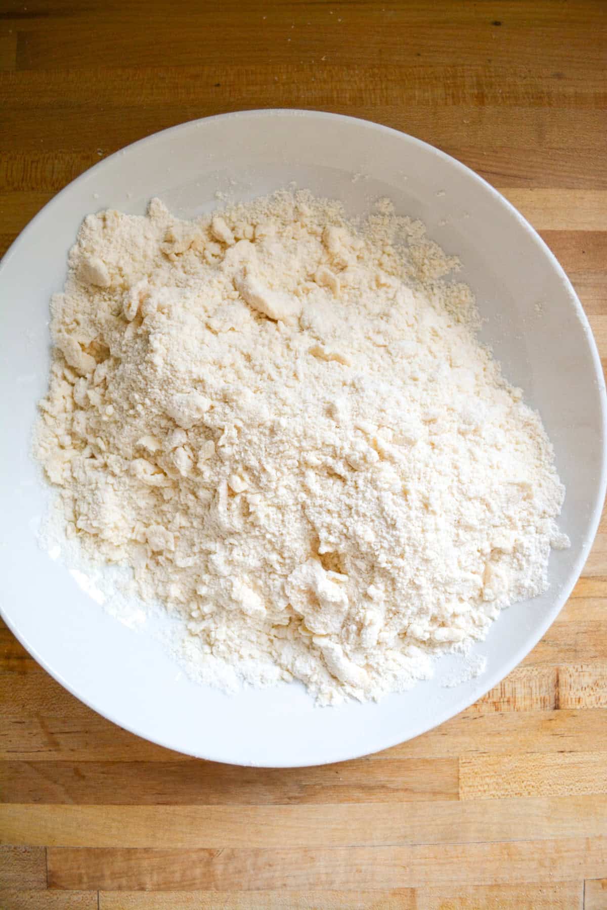 Butter cut into the dry ingredients in a large mixing bowl.