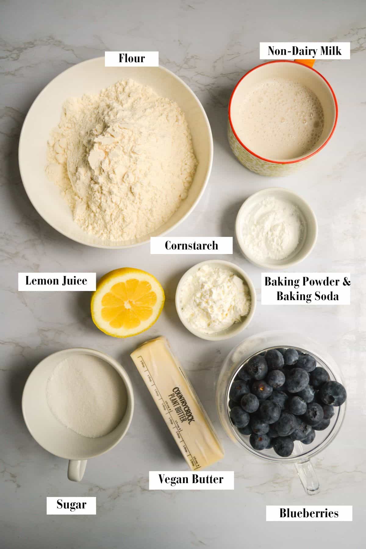 Ingredients for making this recipe in small bowls and cups on a marble surface.