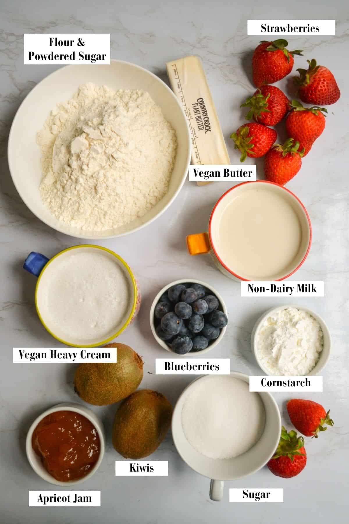 Ingredients for making this recipe in small bowls on a marble surface.