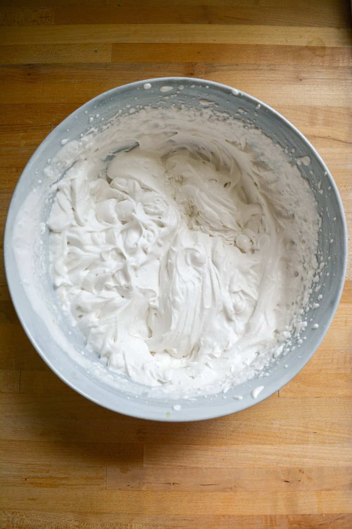 Vegan whipped cream in a large mixing bowl.