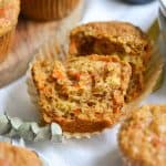 Broken in half banana carrot muffin in a muffin wrapper.