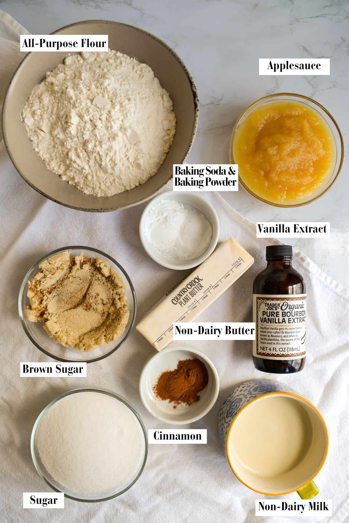 Ingredients for making this recipe in small bowls on a linen surface.