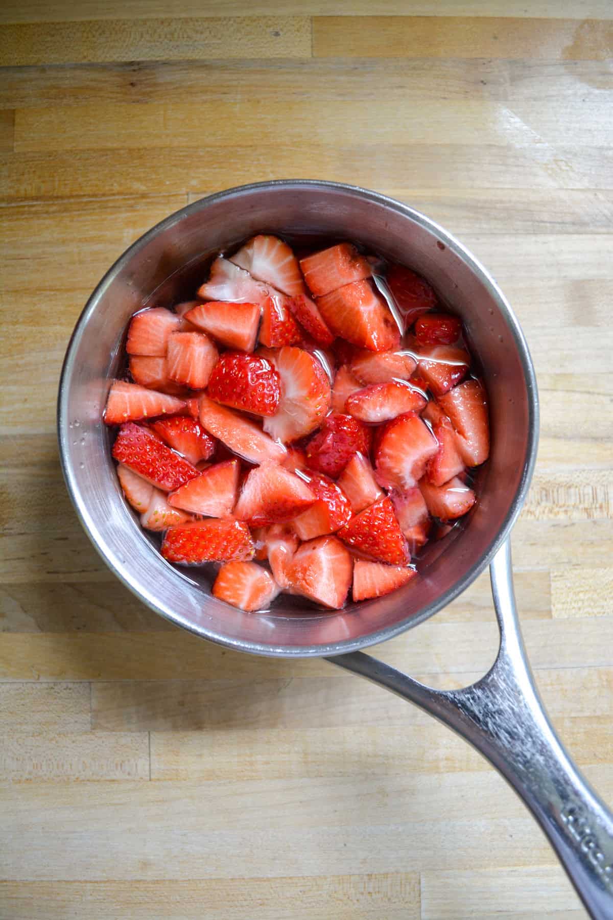 Chopped berries, sugar and water in a saucepan.