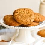 Vegan Chai Cookies stacked on a white cake stand.