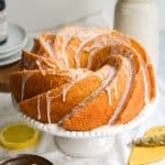 Vegan Lemon Bundt Cake with lemon glaze on a cake stand.