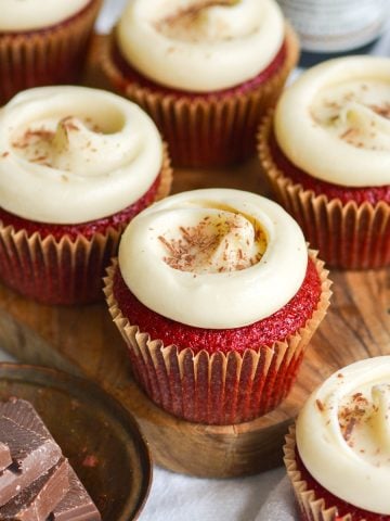 Vegan Red Velvet Cupcakes on a small wooden board.