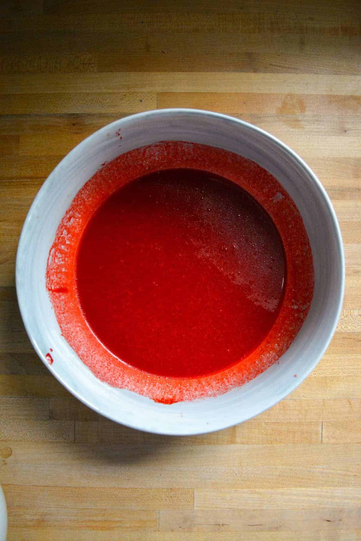 Red liquid in a large mixing bowl.