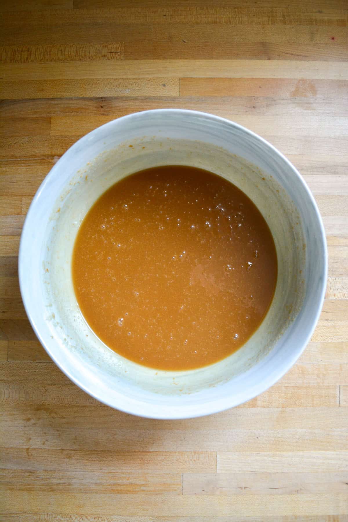 Wet ingredients for making the cupcakes in a marble bowl.