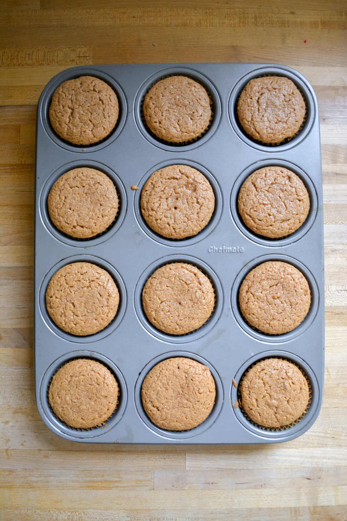 Baked cupcakes in a cupcake tin.