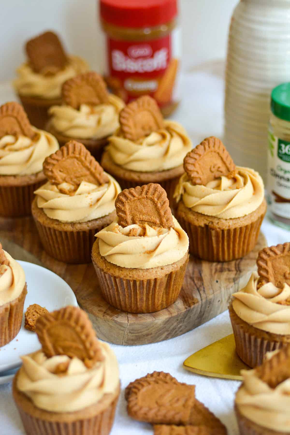 Biscoff Cupcakes with Biscoff frosting on a small wooden cutting board.