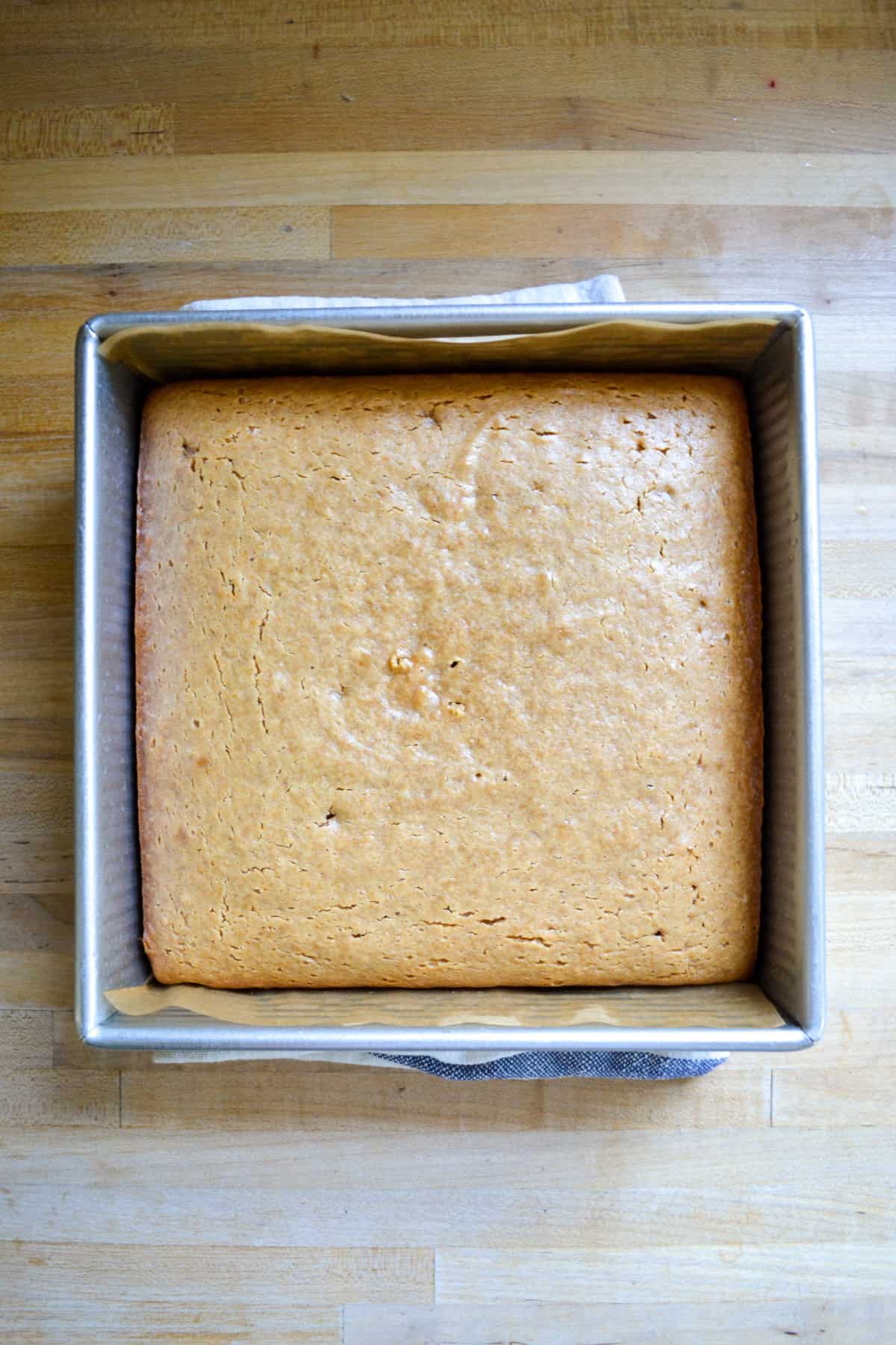 Baked cake in a square pan.