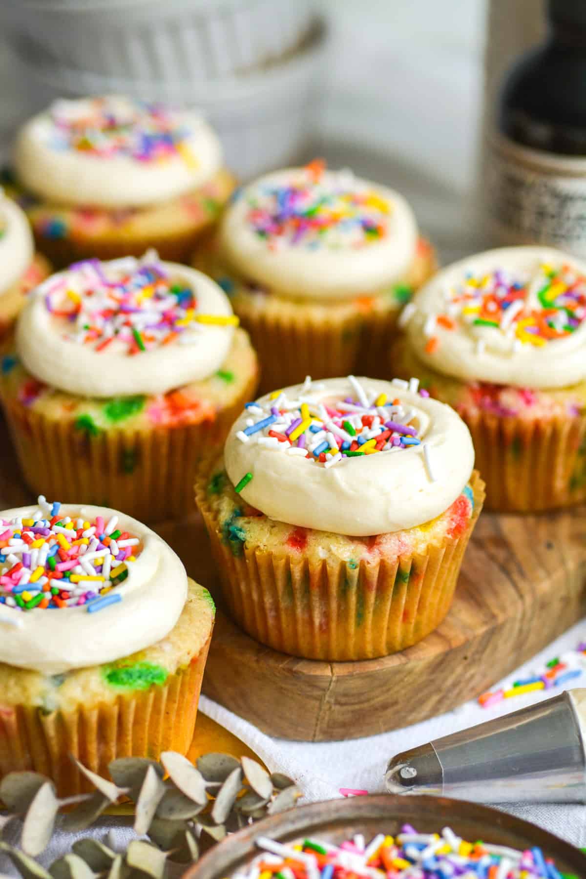 Vegan Funfetti Cupcakes on a small wooden board.