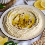 Butter Bean Hummus on a plate topped with olive oil and sumac.