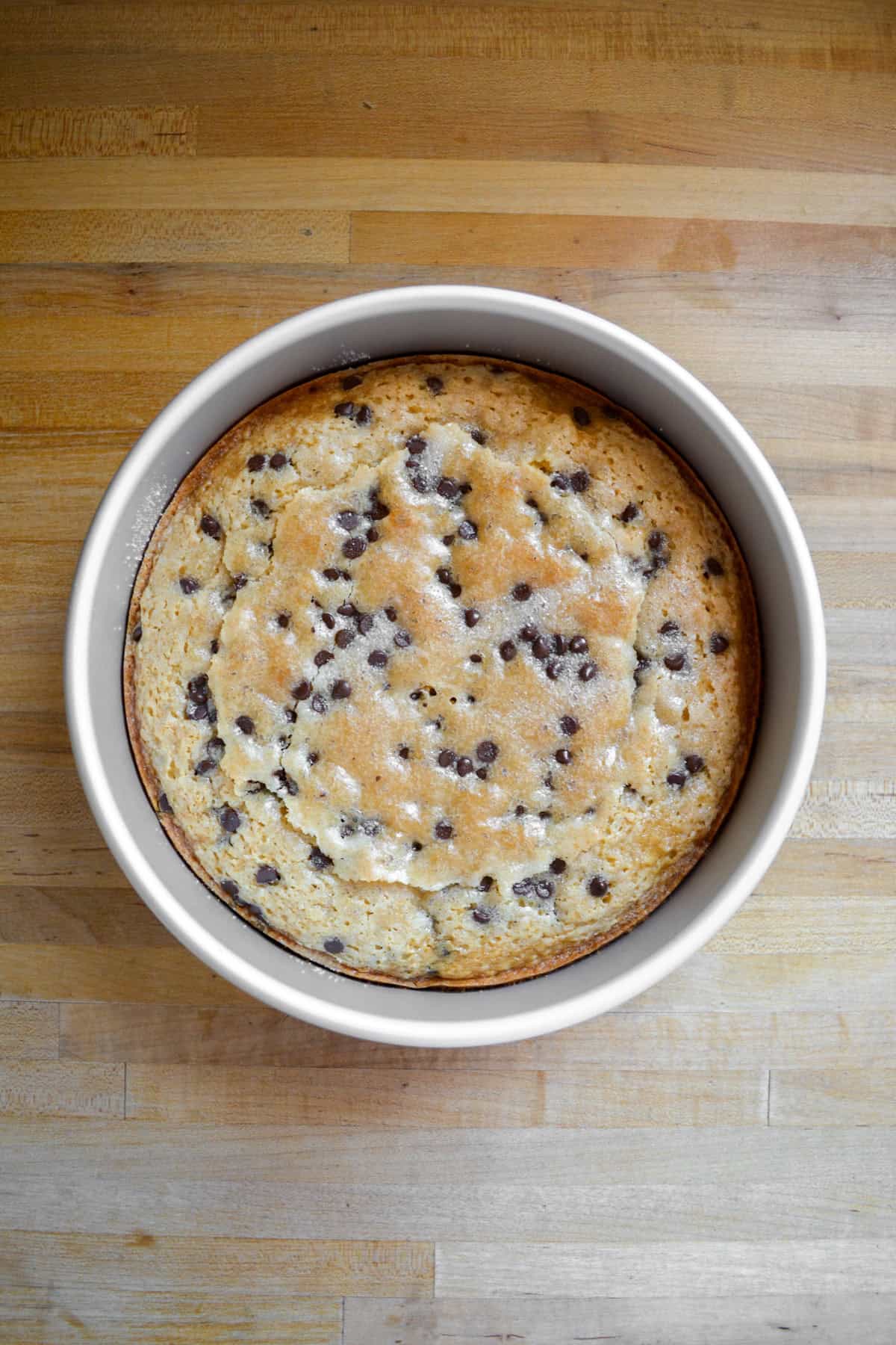 Baked Chocolate Chip Snack Cake in a round cake pan.