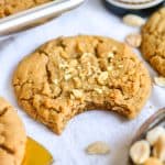 Gluten-Free Vegan Peanut Butter Cookie with a bite taken out of it on a linen cloth.