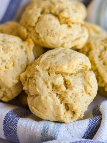 Olive Oil Drop Biscuits in on a striped cloth napkin.