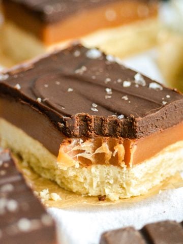 Vegan Millionaires Shortbread with a bite taken out of it.