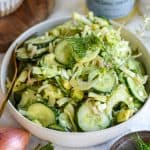 Fennel Cucumber Salad in a shallow bowl with a fork in the bowl.