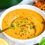 Cauliflower Red Lentil Soup in a bowl topped with chives.