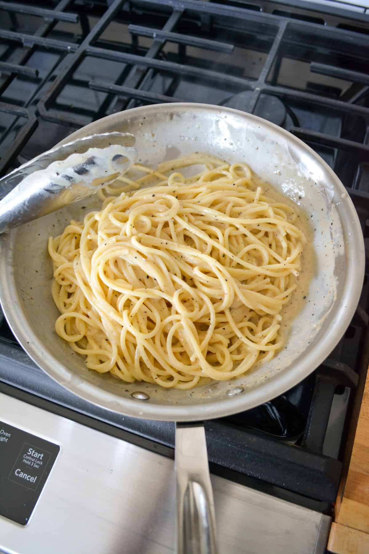 Spaghetti added to the skillet and tossed in the creamy vegan miso butter sauce.