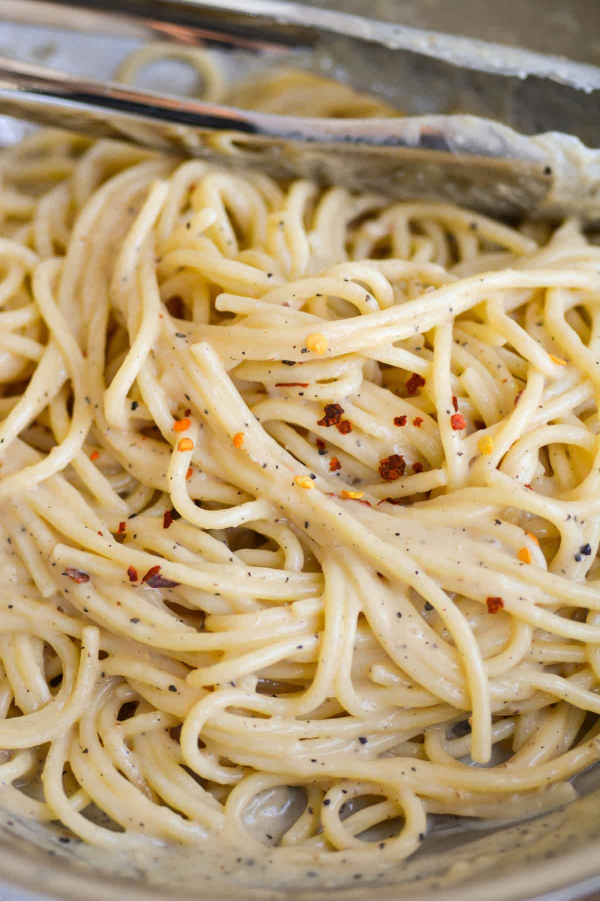 Vegan Creamy Miso Butter Pasta in a skillet topped with crushed red pepper flakes.