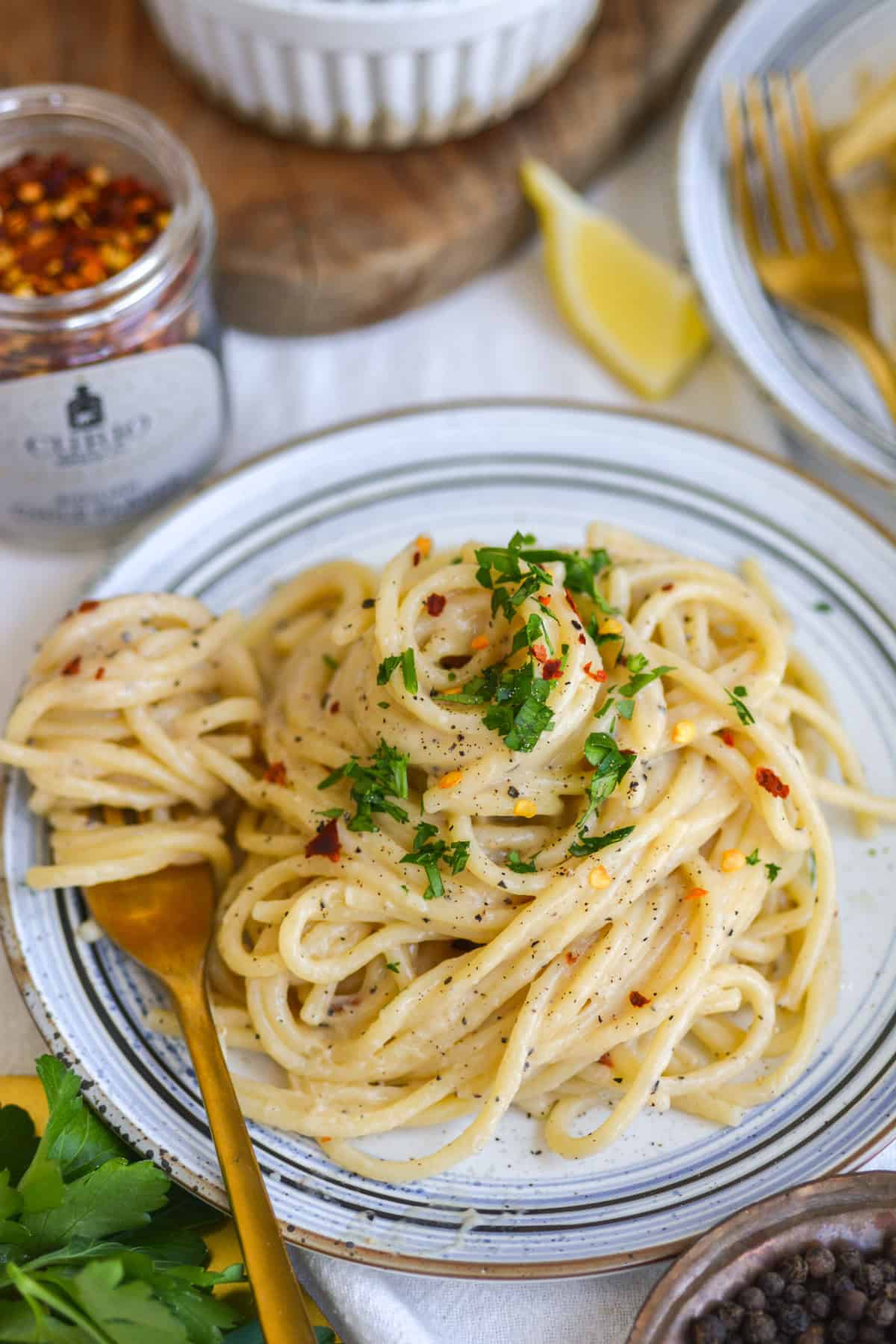 Creamy Miso Butter Pasta on a plate topped with a sprinkle of parsley.