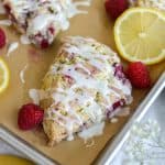 Lemon Raspberry Scone topped with lemon glaze on a baking sheet.