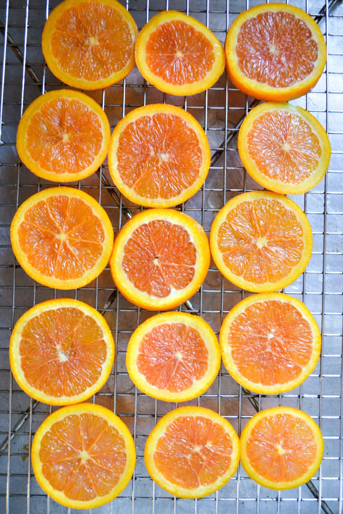 Candied orange slices on a wire cooling rack.