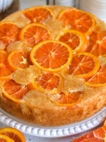 Orange Upside Down Cake on a cake plate.