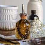 Vanilla Bean Simple Syrup in a glass container with a pouring spout.