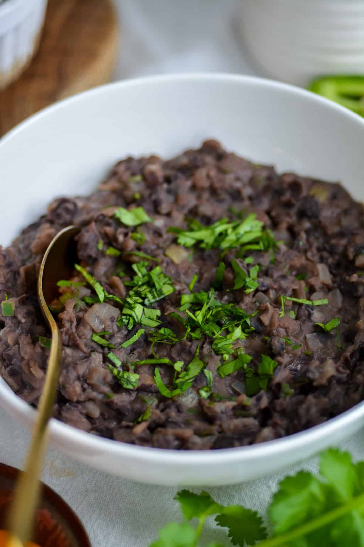 Refried Black Beans in a white bowl.