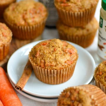 Vegan Carrot Muffin on a small plate with a cinnamon stick.